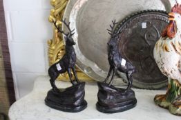 After Moigniez, a pair of bronze stags on rocky outcrops.