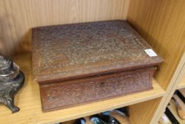 A carved eastern box containing four smaller boxes and a lift-out tray.
