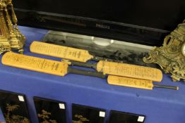 Four miniature cricket bats with facsimile signatures.