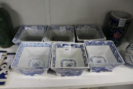 Six decorative Chinese blue and white square form bowls painted with flowers.