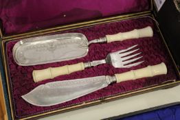 A good cased set of fish servers with matching crumb scoop, all with faux bamboo handles.