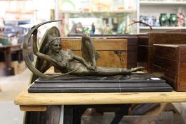 A modern bronze reclining erotic female nude on a marble base.