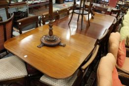 A Georgian style mahogany twin pedestal dining table with one extra leaf.