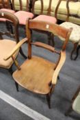 A 19th century beech and elm kitchen armchair.