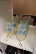 A 1970's set of eight lemonade glasses with glass carrier.