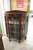 A mahogany bow fronted display cabinet.