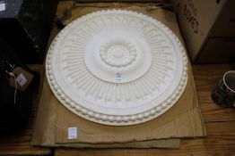 A pair of large decorative circular moulded plaster ceiling bosses.