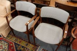 A pair of stylish Danish teak armchairs.
