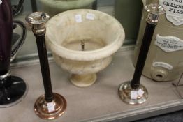 A pair of decorative plated and wooden candlesticks.