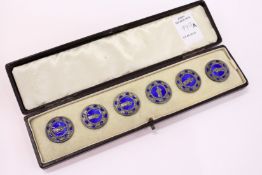 A cased set of six enamel buttons.