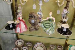 A pair of Susie Cooper coffee cups and saucers, a Royal Doulton figurine 