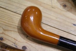 A gold putter style walking stick.