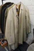 A gentlemen's classic Burberry beige raincoat and a similar coat.