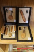 Four small Japanese models of musical instruments and two Japanese combs.