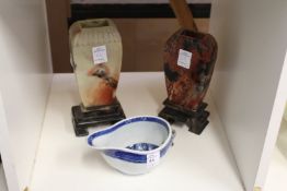A Chinese porcelain sauceboat and two Chinese soapstone vases on stands (AF).
