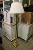 A brass floor standing lamp.