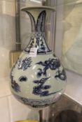 A large Chinese blue and white bottle vase painted with a dragon chasing the flaming pearl of