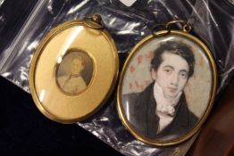 A portrait miniature of a young gentleman with hair back and another portrait miniature.