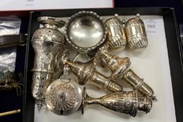 A good collection of silver pepperettes and condiments.