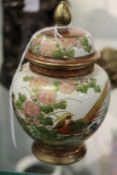 A small Japanese vase and cover painted with an exotic pheasant.