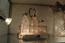 A plated and cut glass six bottle cruet.