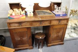 An early 20th century Indian teak pedestal sideboard with upper section over three frieze drawers