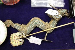 A gilt metal model of a dragon and anther item.