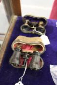 Two leather cased opera glasses.