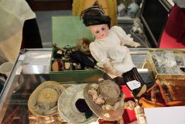 A German porcelain headed doll with numerous accessories.