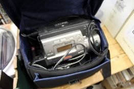 A video camera and accessories, in a Handycam case.