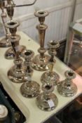 Three pairs of plated candlesticks.