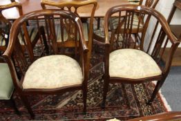 A pair of inlaid mahogany horseshoe shaped armchairs.