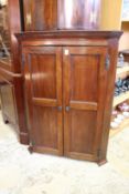 A 19th century mahogany two door hanging corner cabinet.