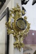 A gilt metal Cartel style wall clock.