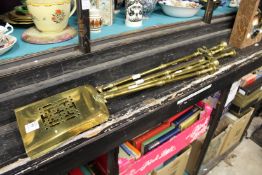 Five brass fireside tools.