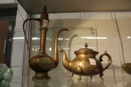 An eastern brass ewer and similar teapot.