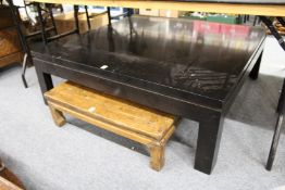 A modern large ebonised square shaped coffee table.