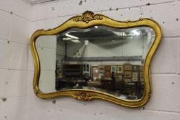 A decorative gilt framed mirror.