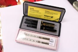 Two cased pen sets.