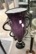 A large amethyst glass vase.