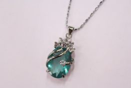 A decorative pendant and chain, boxed.