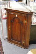 A 19th century oak hanging corner cabinet.