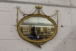 An Adam's revival gilt framed oval wall mirror.