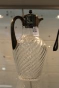 A silver mounted cut glass claret jug.