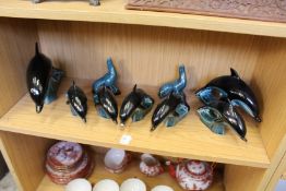 A quantity of Poole pottery dolphins and sea lions.