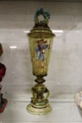 A good decorative continental amber glass goblet and cover decorated with a man holding a large
