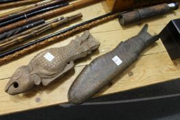 Two carved fish shaped moulds.