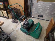 A Qualcast petrol cylinder lawn mower.