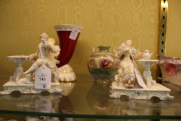A pair of porcelain figure groups, a cornucopia vase and another vase.