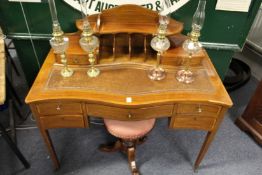 A Sheraton revival inlaid mahogany serpentine fronted desk.